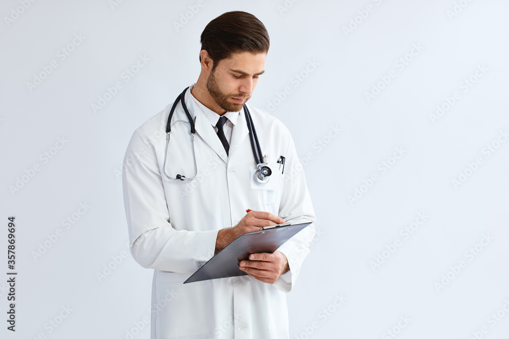 Studio portrait of a focused looking male doctor against a white background Studio portrait of a focused looking male doctor against a white background