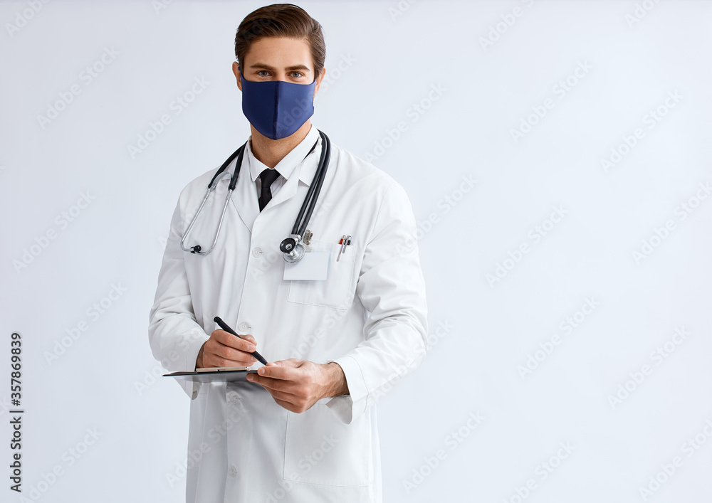 Male doctor wearing protective face mask to prevent from virus disease, studio. Male doctor wearing protective face mask to prevent from virus disease, studio.