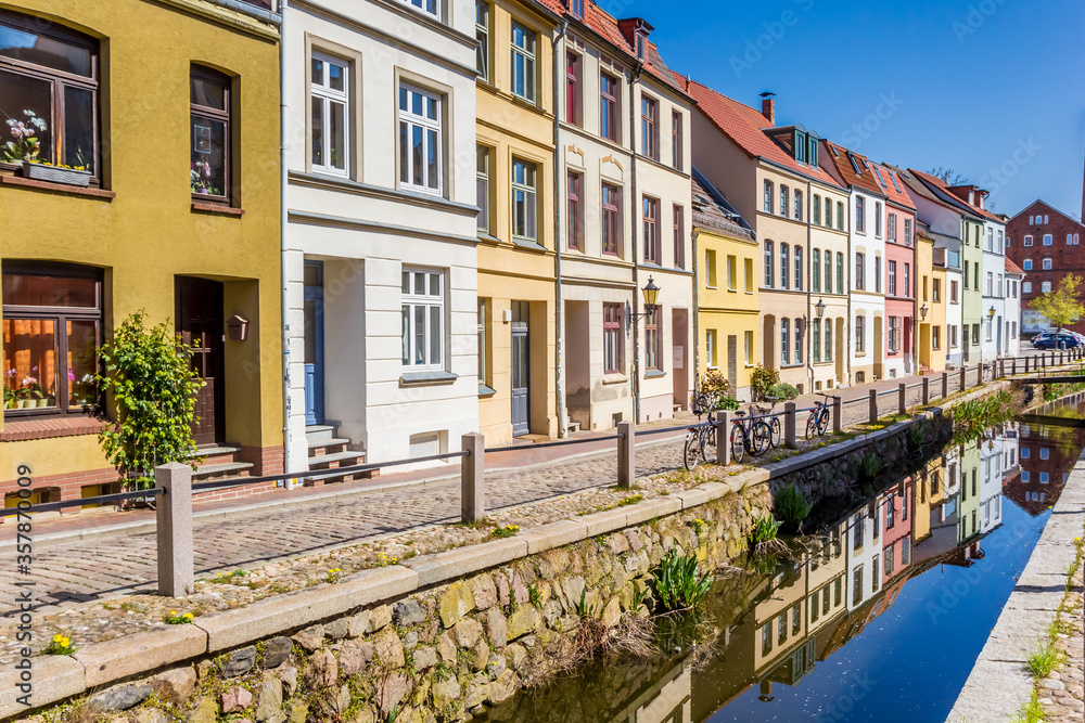 Colorful houses with reflection in the canal in Wismar, Germany