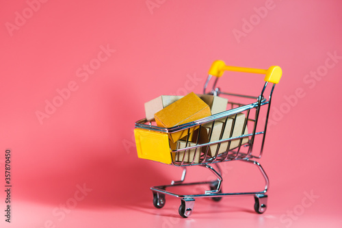 Mini shopping cart contain paper box using as e-commerce, online shopping and business marketing concept