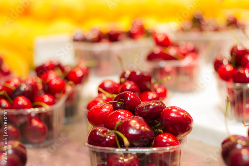 Cherries exposed in the market. Red colors. fruits in the market. Background. Selective blur.