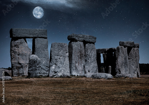 Stonehenge at night with a full moon and silvery blue light