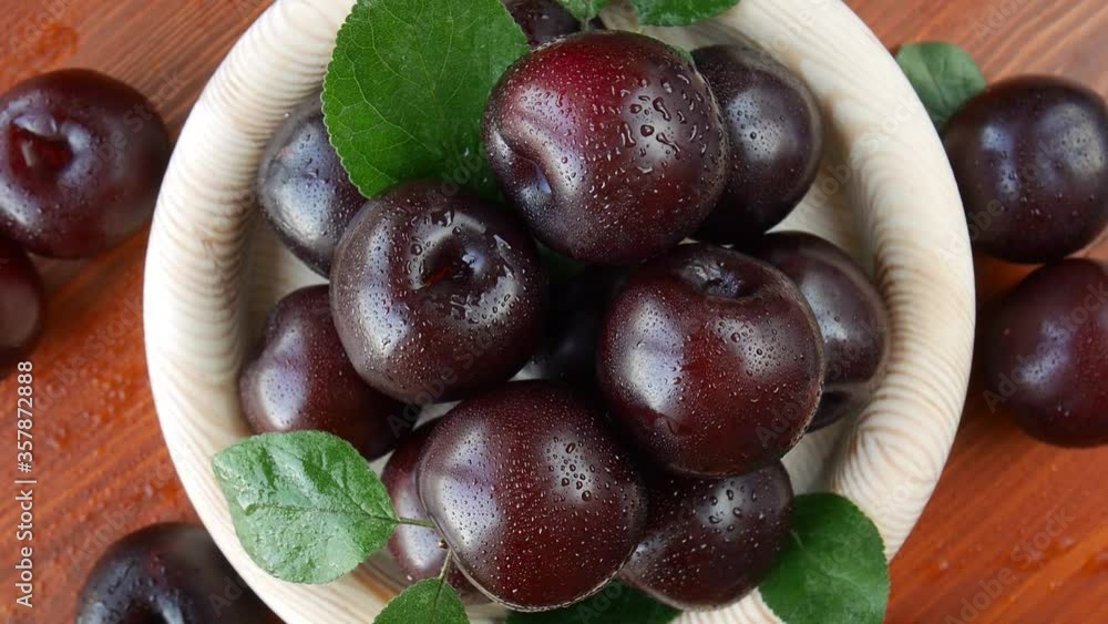 Plums in a wooden bowl. Seamless. Loop. looping. Plums in a wooden bowl. Seamless. Loop. looping.