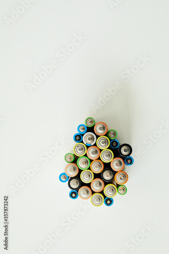 High angle view of different kinds of alkaline battery sorting for recycling isolated on white background
