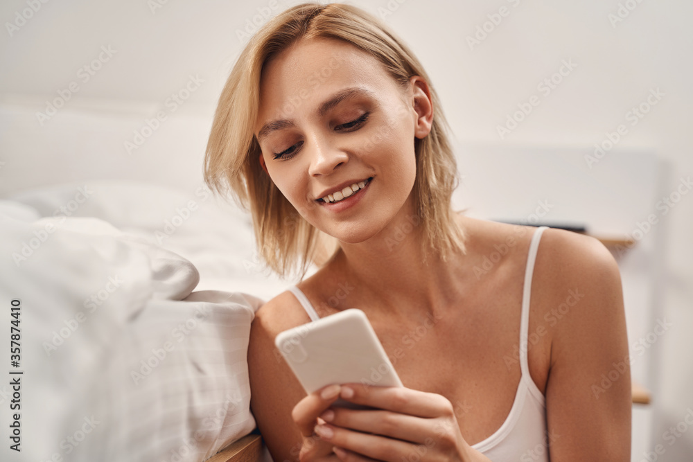 Female reading a text message on her smartphone Female reading a text message on her smartphone