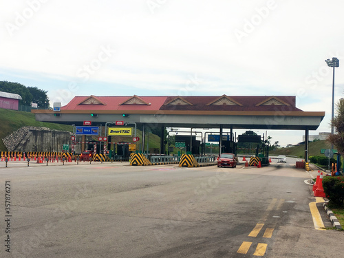 SEREMBAN, MALAYSIA -MAY 26, 2020: Highway toll canopy in Malaysia. Vehicles that use the expressway through a toll plaza and make payments each time they enter and exit.