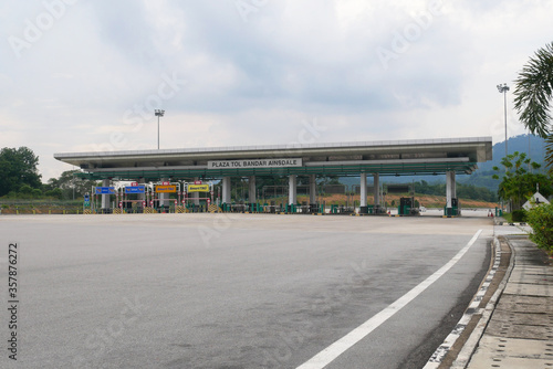 SEREMBAN, MALAYSIA -MAY 26, 2020: Highway toll canopy in Malaysia. Vehicles that use the expressway through a toll plaza and make payments each time they enter and exit.