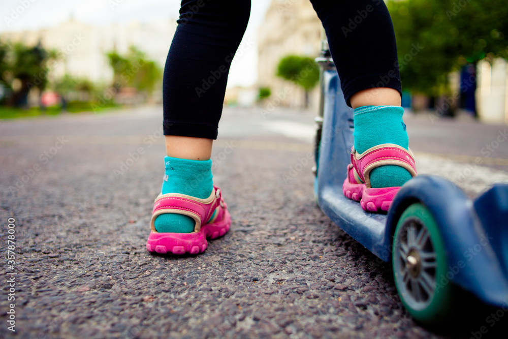 Girl about to ride a bike on the street. Only leg view Girl about to ride a bike on the street. Only leg view