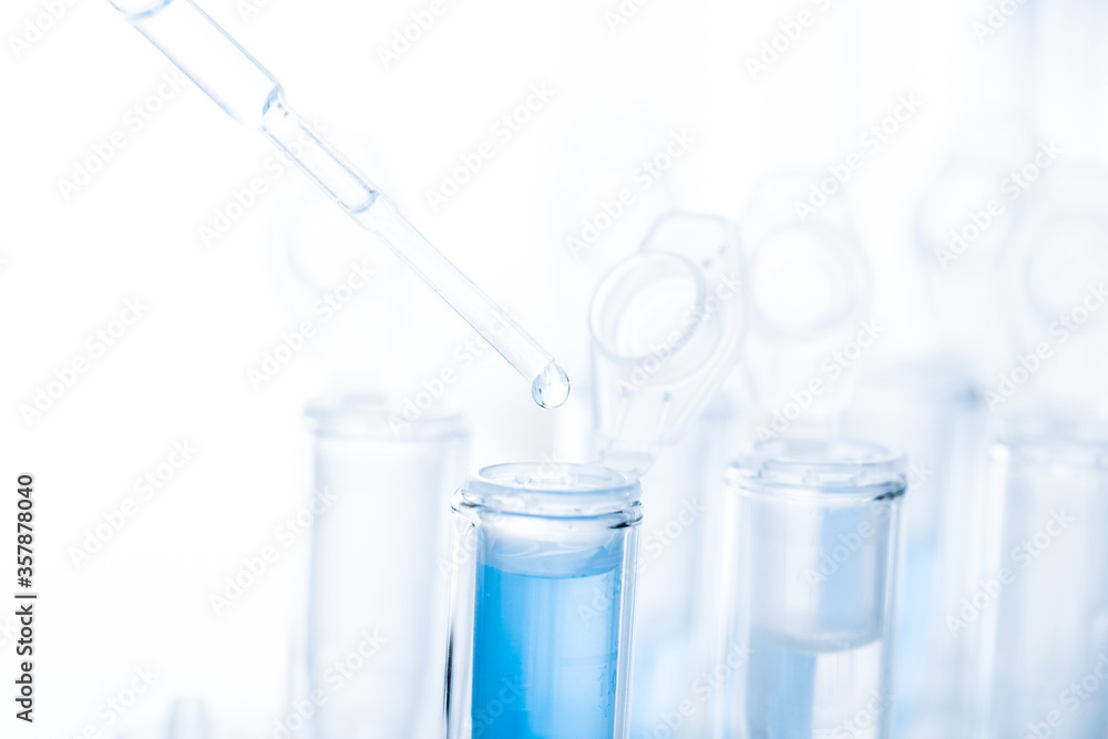 microbiological pipette in the genetic laboratory. study of a virus or vaccination. blue tinted. microbiological pipette in the genetic laboratory. study of a virus or vaccination. blue tinted.