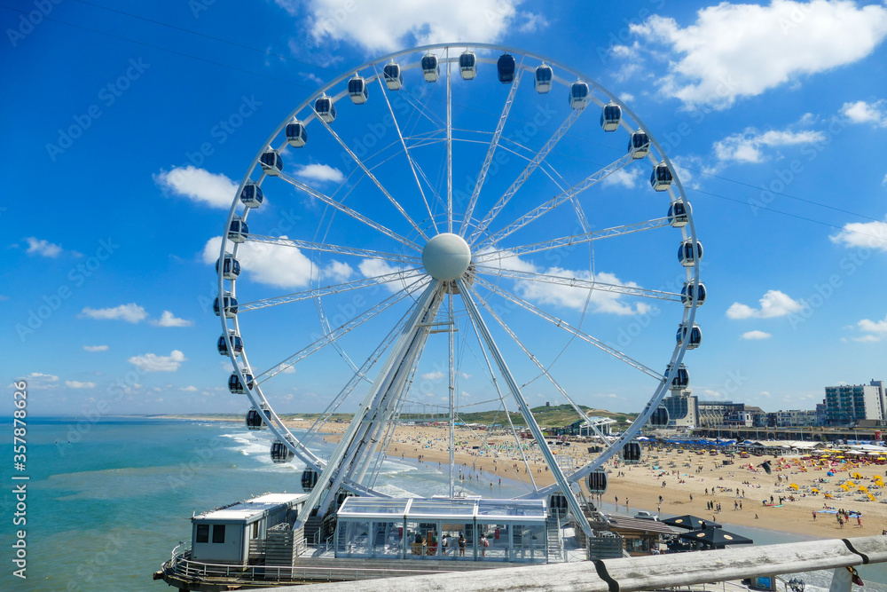 Ferris Wheel of Scheveningen in front of crowded beach. High quality photo