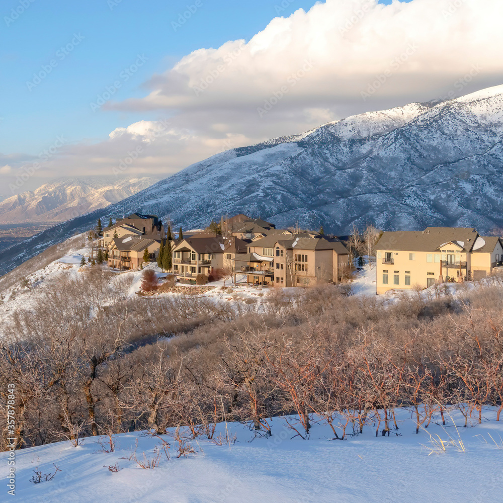 Square crop Wasatch Mountains landscape in winter with houses sitting on the snowy slope