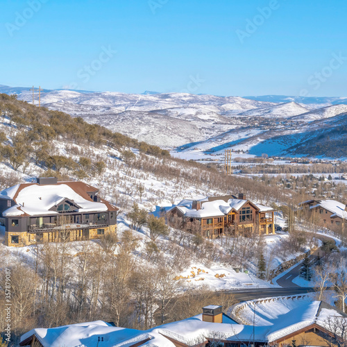 Square crop Luxurious homes in Park City on mountain landscape blanketed with snow in winter