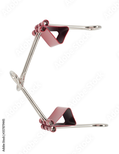 Letter C red binder clips alphabet. Office metal foldback braces. Metal binder clips isolated on white background photo