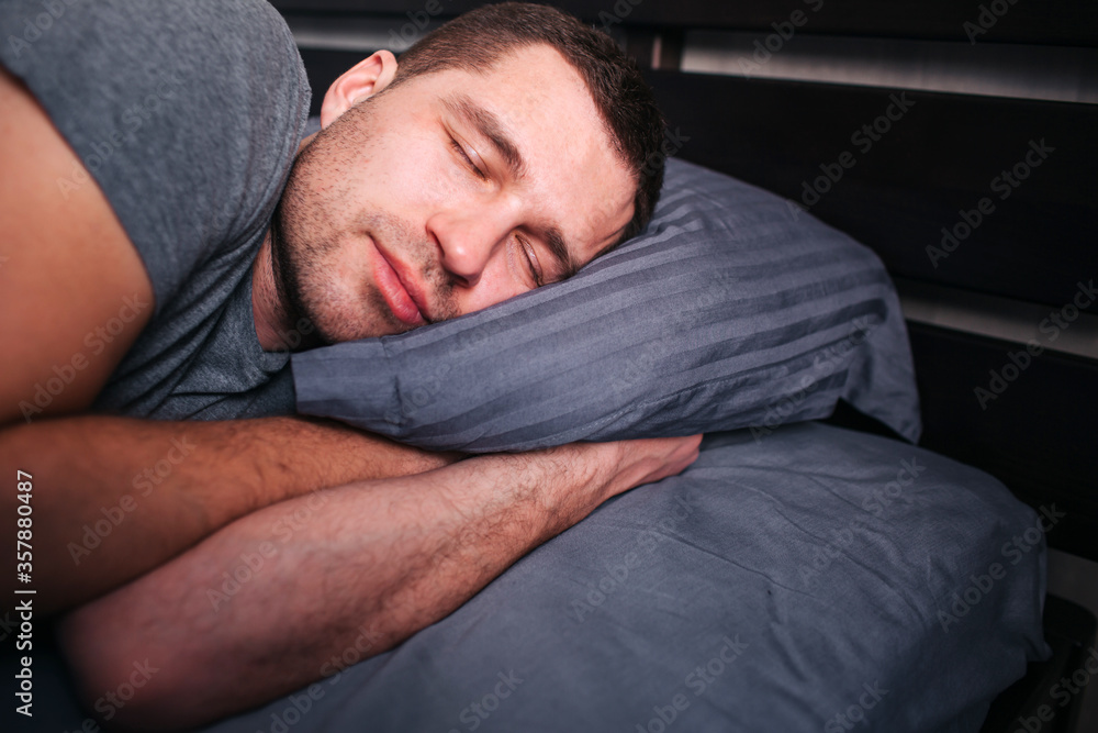 no strength to get out of bed in the morning. A man in the morning in the bed does not want to wake up. no strength to get out of bed in the morning. A man in the morning in the bed does not want to wake up.