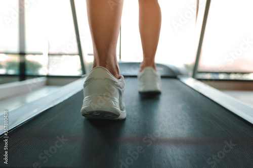 Close up woman running on machine treadmill at fitness concept for exercising, fitness and healthy.