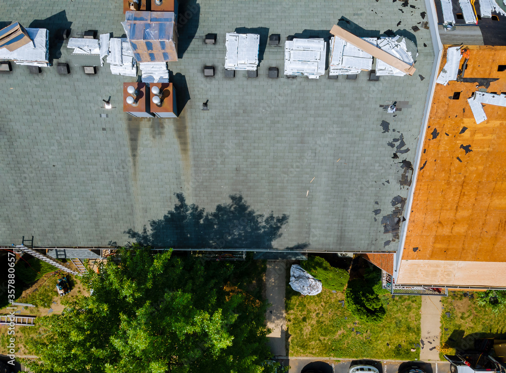 Removal of old roof and replacement with new roof shingle being applied