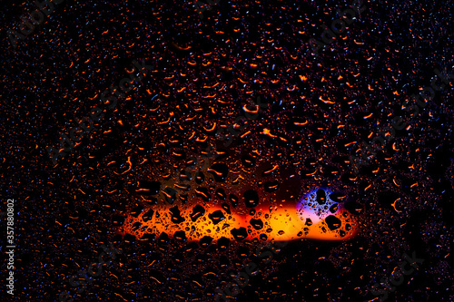 Drops of water on a wet glass on light background