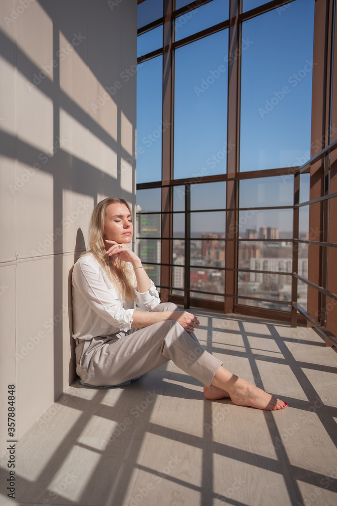 Woman depression. Young female sitting on the balcony eyes closed. Try to relax.