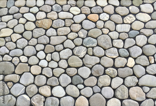 Wall or fence texture with pebble stones