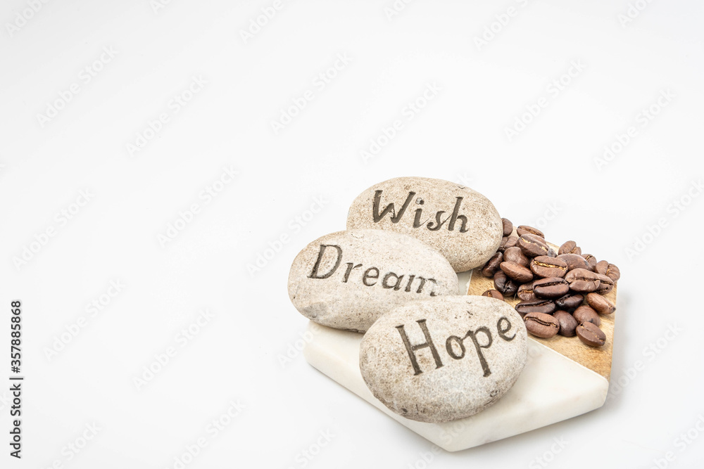 coffee beans on a cutting board with insirational stones on a white background coffee beans on a cutting board with insirational stones on a white background
