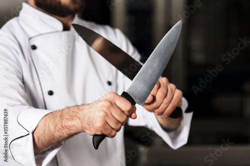 Professional chef hands with knives. Closeup male hands with crossed knives.