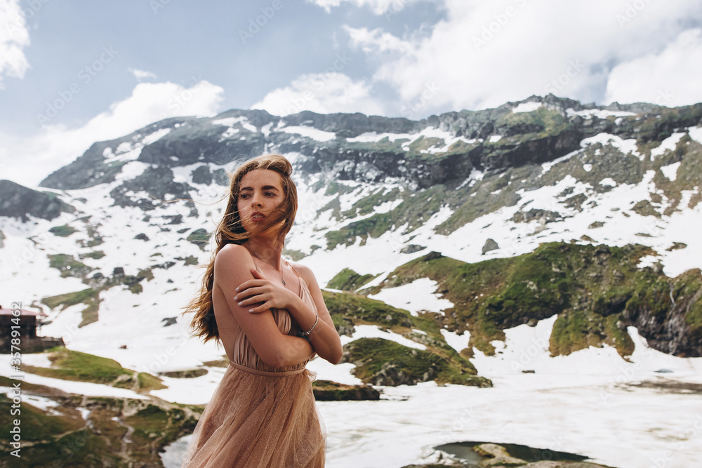 beautiful young girl in long dress at the mountains