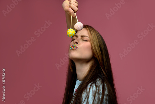 young european woman playes cake pops
