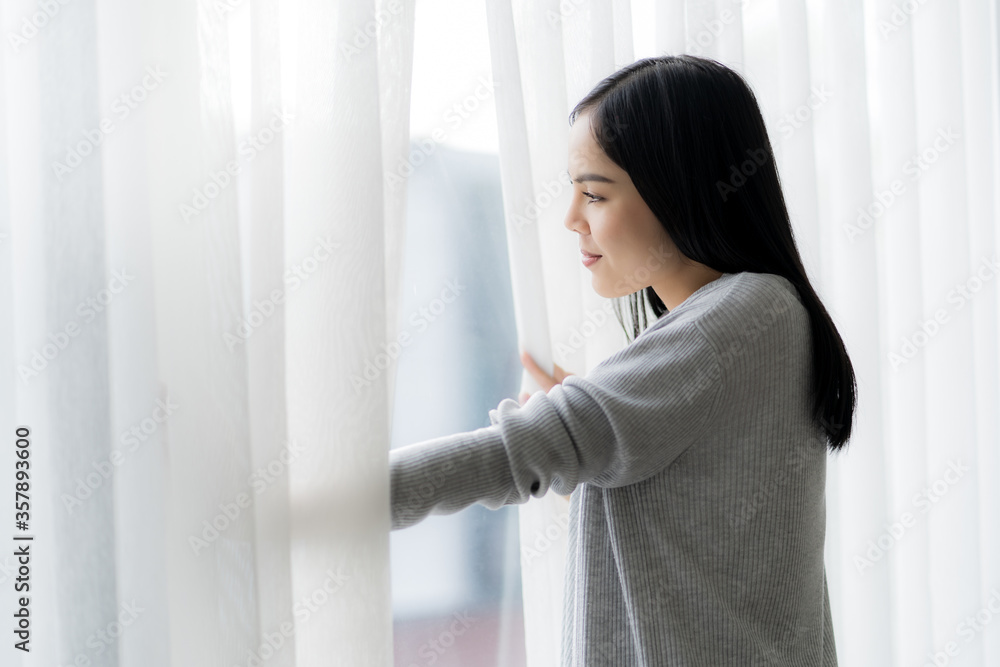 Portrait of young beautiful with the beautiful sunrise near the window at home