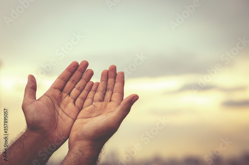 Human hands open palm up worship Praying with faith and belief in God of an appeal to the sky. Concept Religion and spirituality with believe Power of hope or love and devotion. filler tone vintage. © methaphum