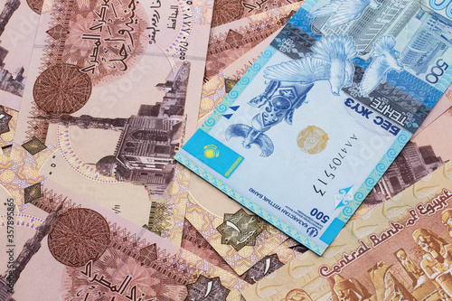 A blue five hundred tenge note from Kazakhstan with Egyptian one pound bank notes close up in macro