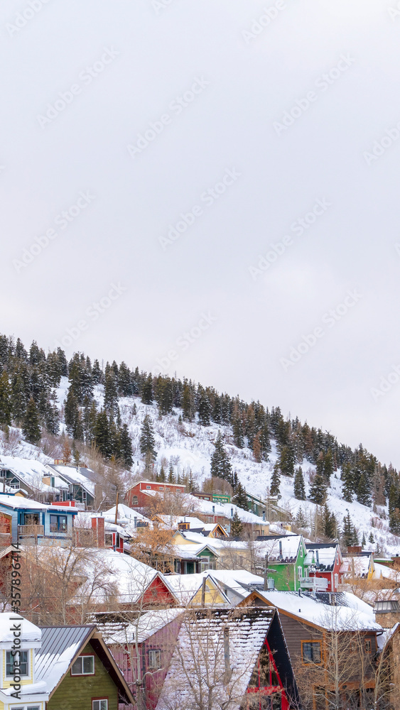 Vertical crop Park City residential community with colorful home cabins on snowy mountain
