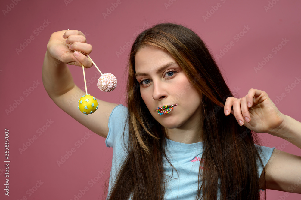 young european woman playes cake pops young european woman playes cake pops