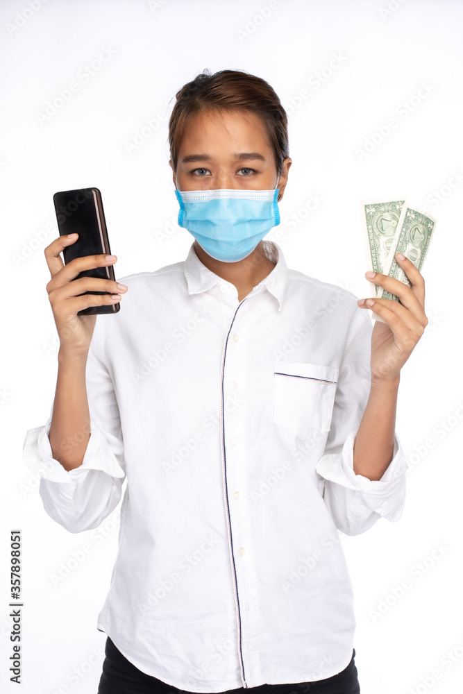 Asian woman in white shirt holding dollar banknote and smartphone, look at camera, isolated on white background, COVID-19 concept Asian woman in white shirt holding dollar banknote and smartphone, look at camera, isolated on white background, COVID-19 concept