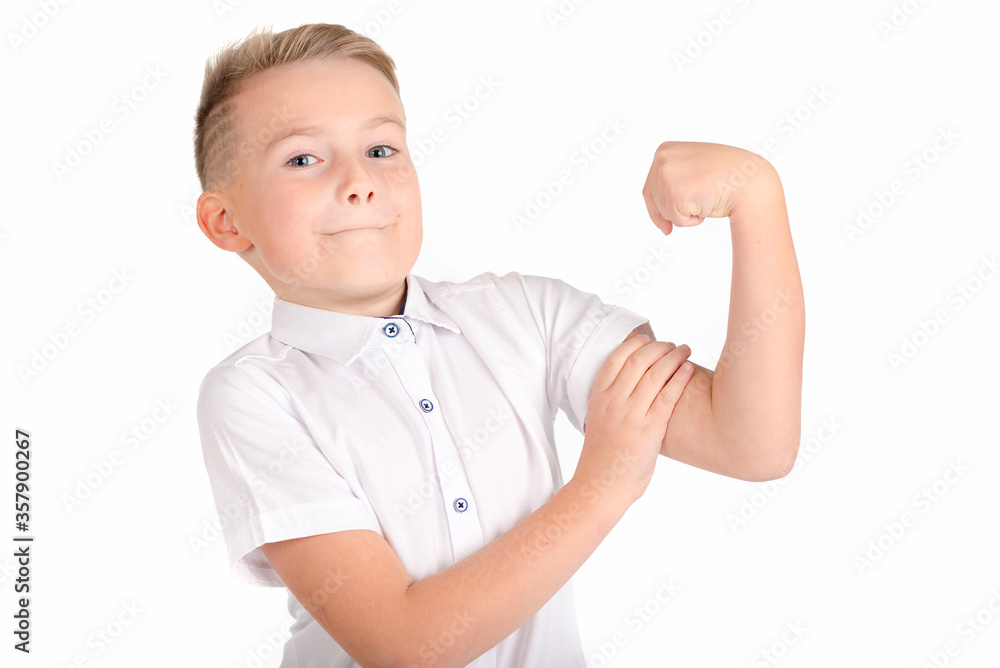 Close up image.The strong smiling school boy on a white background shows the force. Close up image.The strong smiling school boy on a white background shows the force.