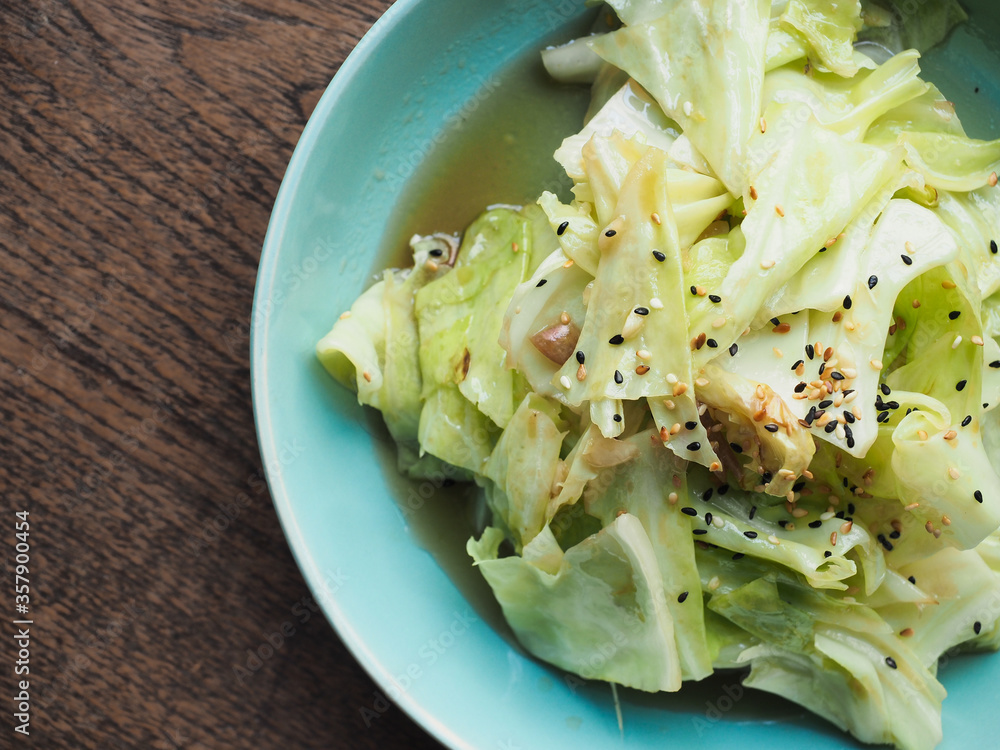 Top view dish of fried cabbage with soy sauce with black and white sesame seed Top view dish of fried cabbage with soy sauce with black and white sesame seed