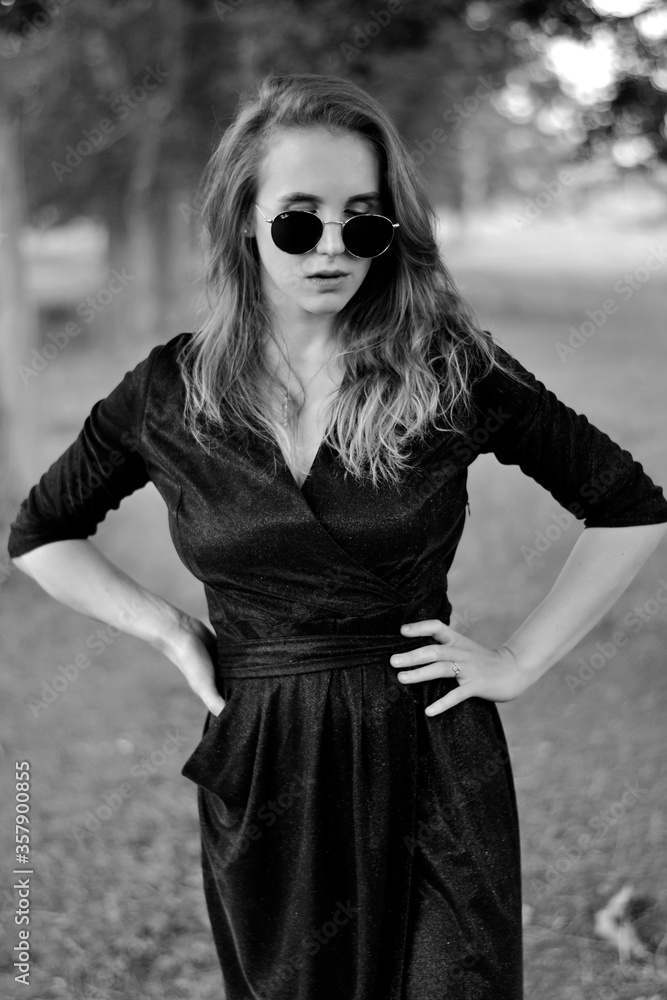 Black and white photo of a young girl in a black dress Black and white photo of a young girl in a black dress