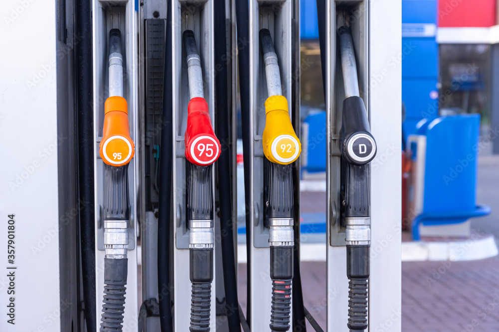 Service gas station with fuel, oil, gasoline and diesel, side view. Close-up of a gas pump fueling gun. Petrol station. Service gas station with fuel, oil, gasoline and diesel, side view. Close-up of a gas pump fueling gun. Petrol station.