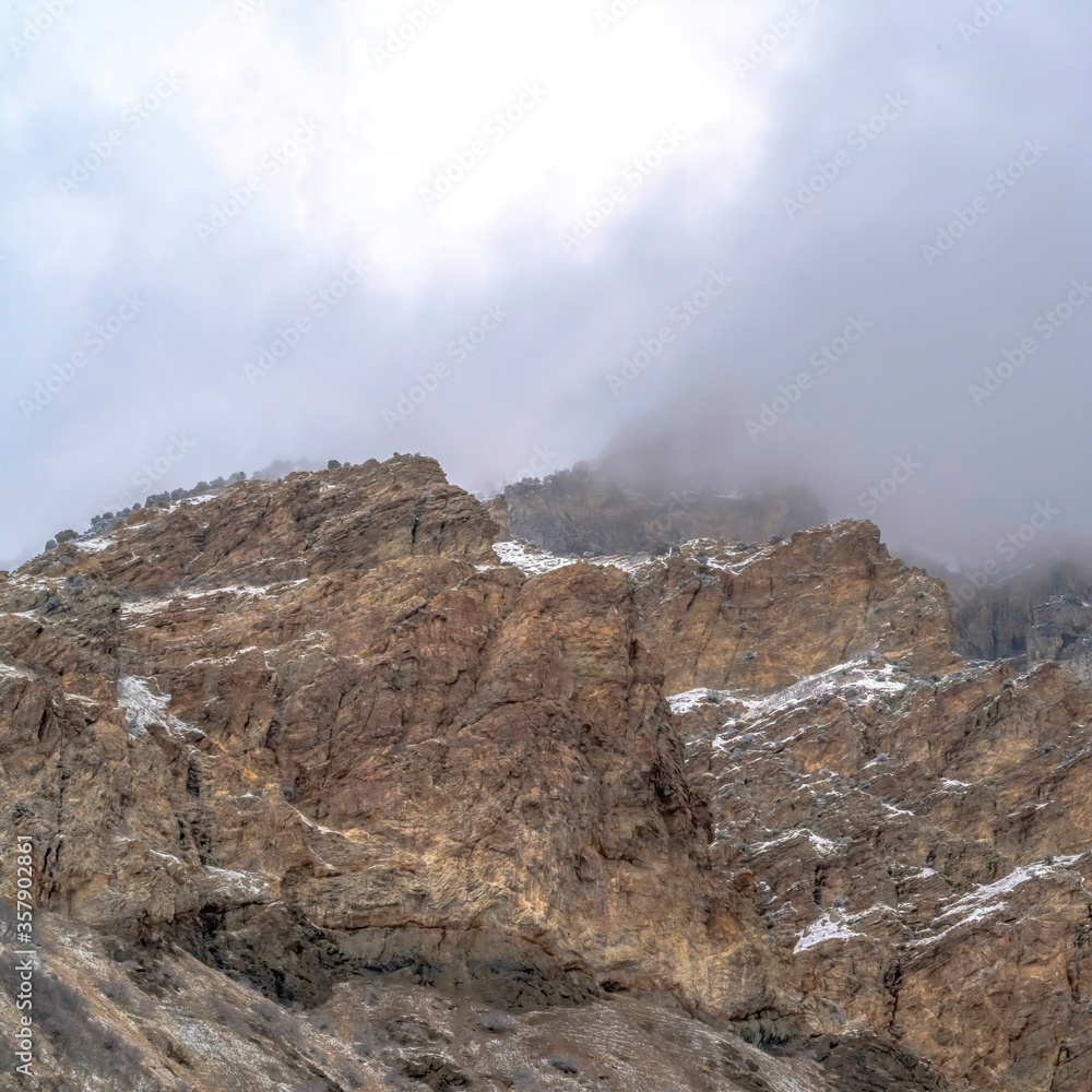 Square frame Rocky mountain scenery with overcast sky overhead in Provo Canyon Utah in winter Square frame Rocky mountain scenery with overcast sky overhead in Provo Canyon Utah in winter