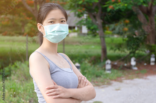 firness girl wearing medical face mask at park photo