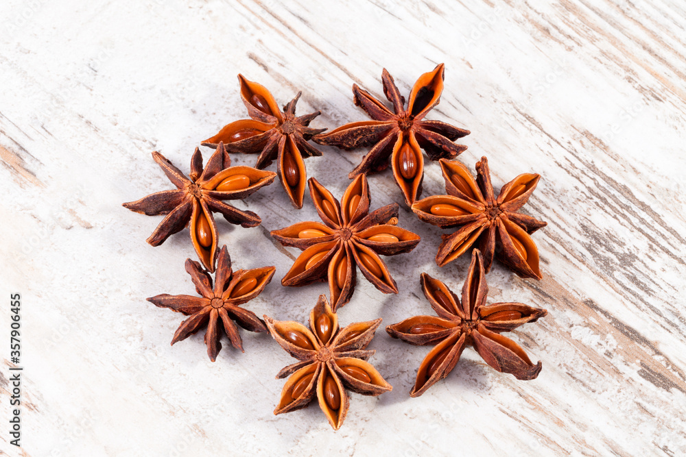 Some star anise fruits on a wooden board, close up Some star anise fruits on a wooden board, close up