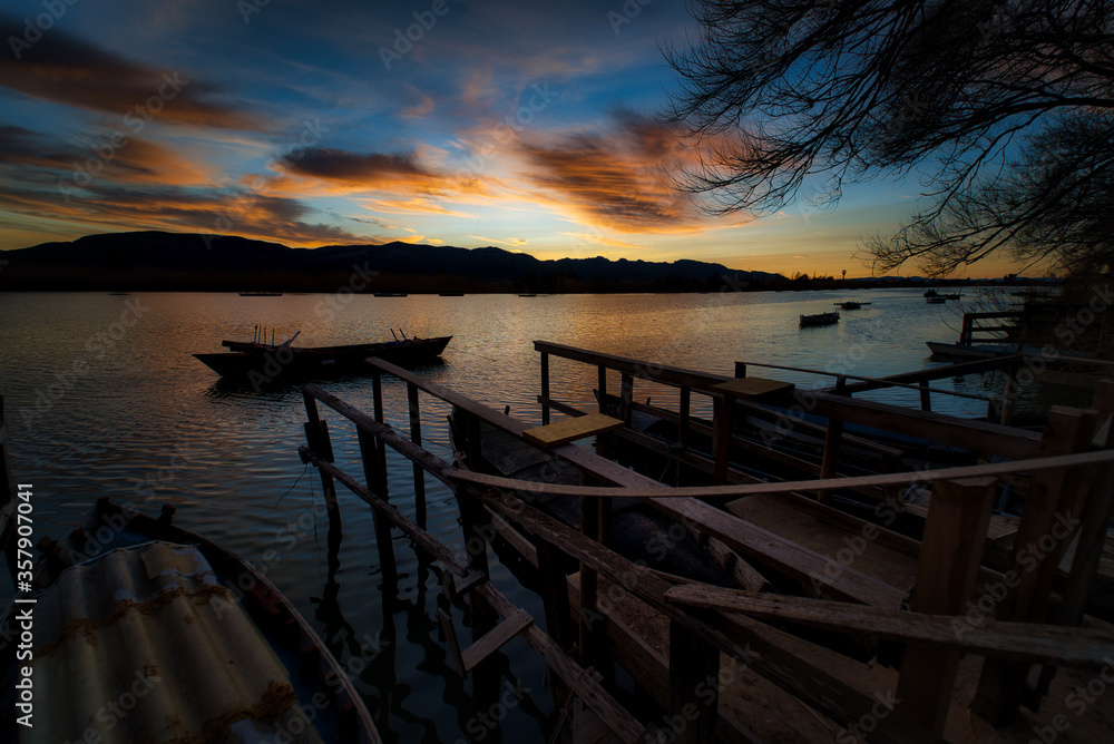 a boat the lake at sunset