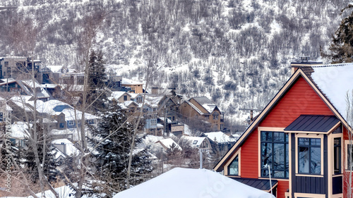 Panorama Houses in snowy Park City Utah mountain with abundant trees in the background