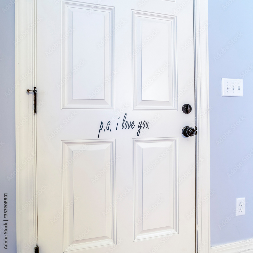 Square White interior wooden door in a blue wall Square White interior wooden door in a blue wall