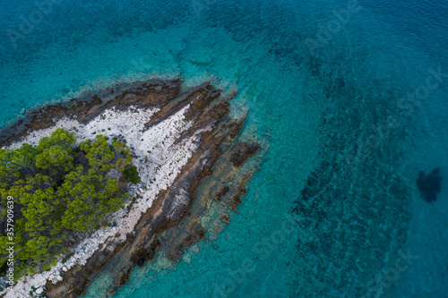 Aerial view of a rocky coast in clear blue sea