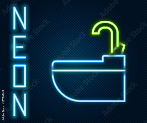 Glowing neon line Washbasin with water tap icon isolated on black background. Colorful outline concept. Vector Illustration