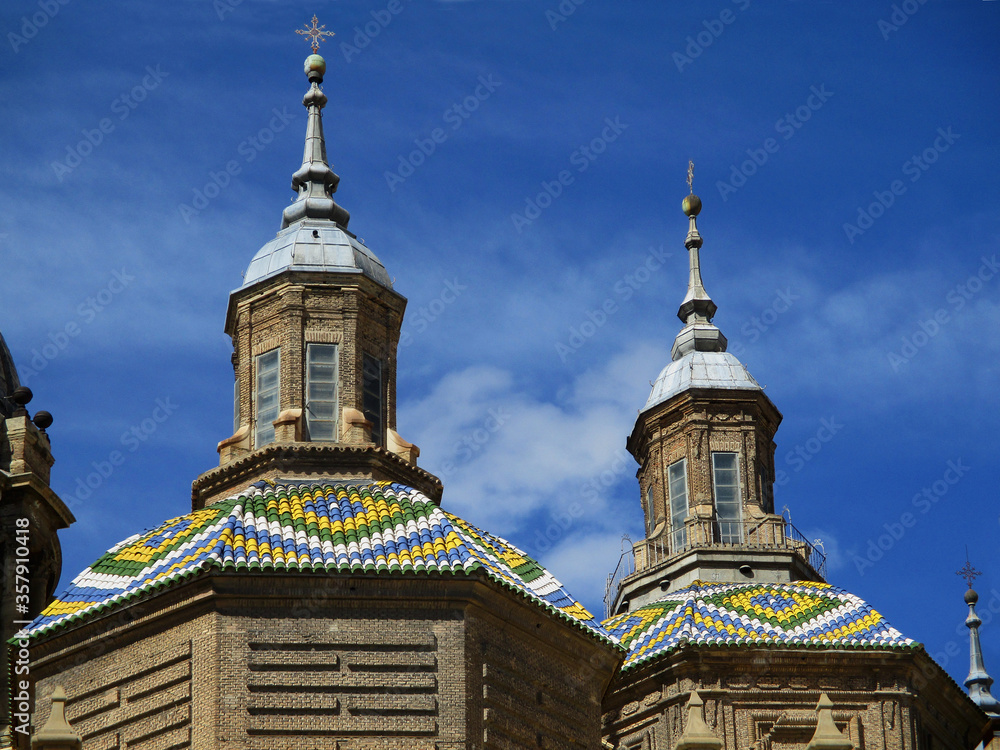 Baroque Basilica of El Pilar in Zaragoza. Spain.
Detail of two colorful tiled cupolas. 
