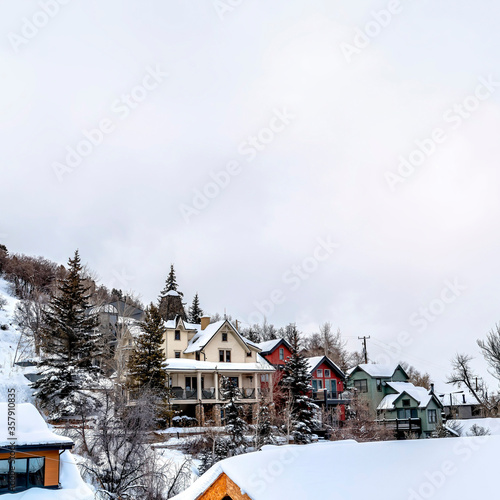 Square Overcast sky over residential neighborhood on snow covered slope of a hill © Jason