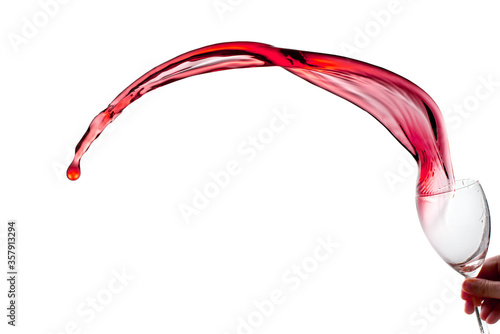 Red wine splashes from glass isolated on white background