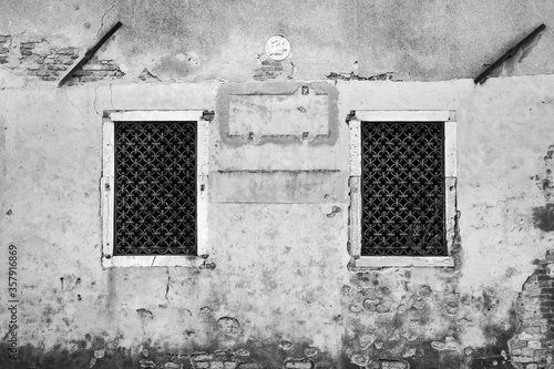 old plaster wall with iron windows