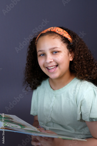 Portrait of a hispanic girl reading a book